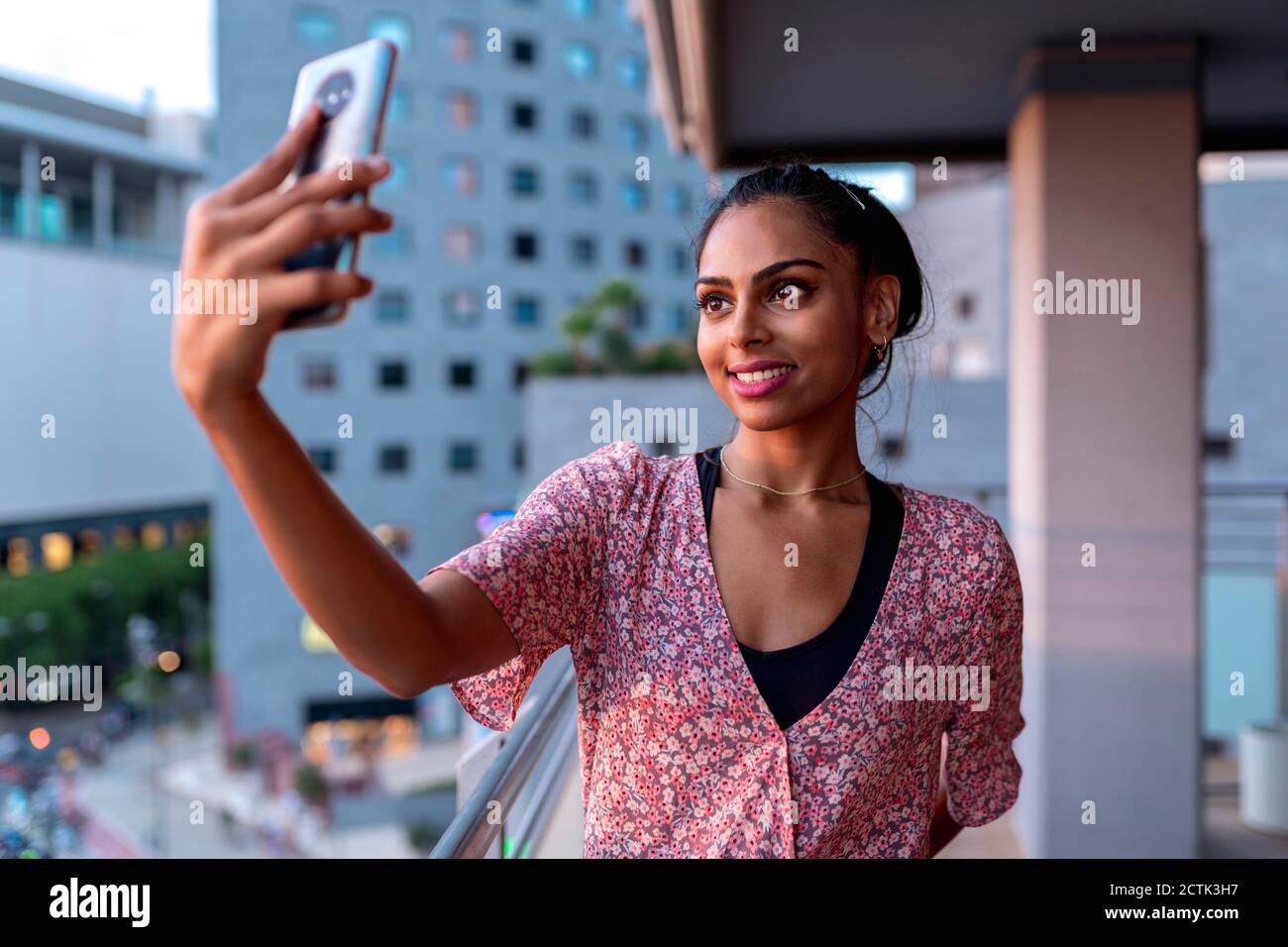 Happy woman taking selfie in balcony Stock Photo - Alamy
