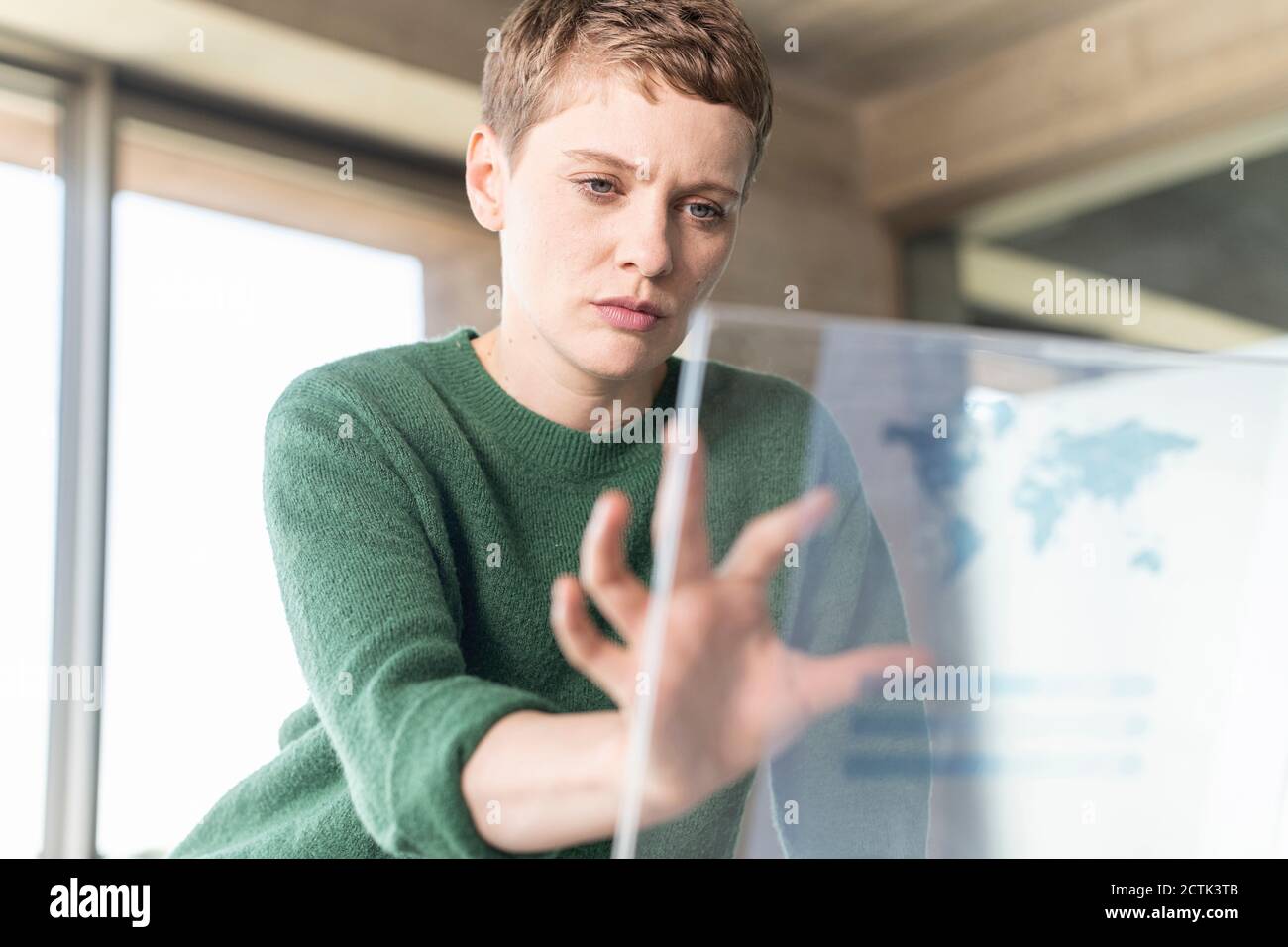 Businesswoman in office using virtual screen Stock Photo