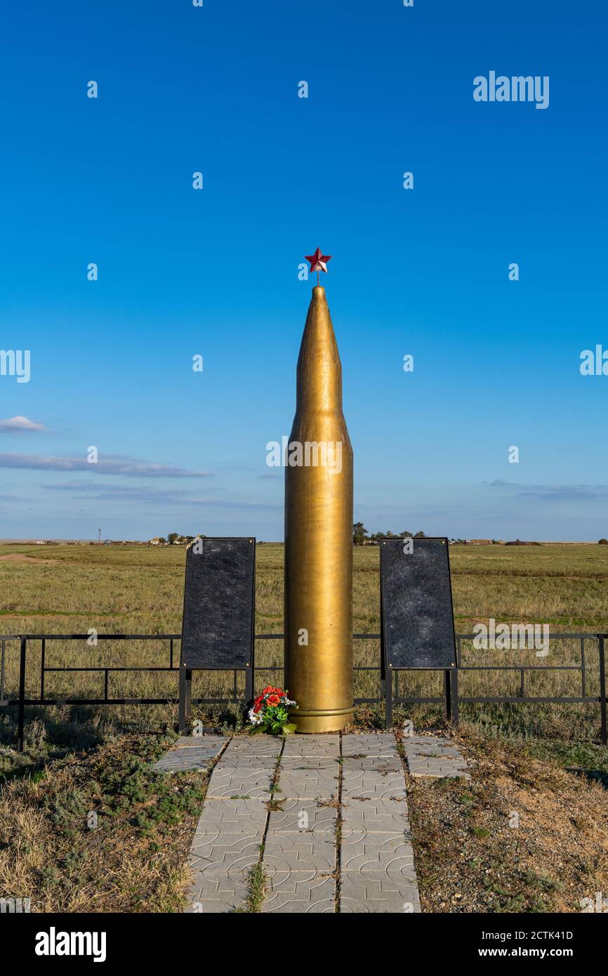 Russia, Republic of Kalmykia, Giant gold colored rifle bullet monument Stock Photo