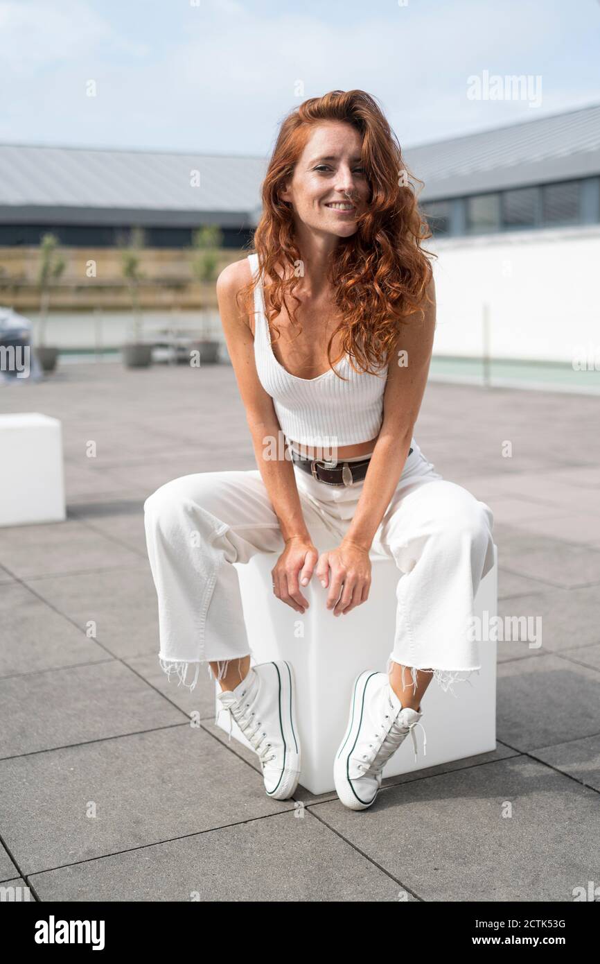 Posing on the white cube. Woman in underwear with slim body type