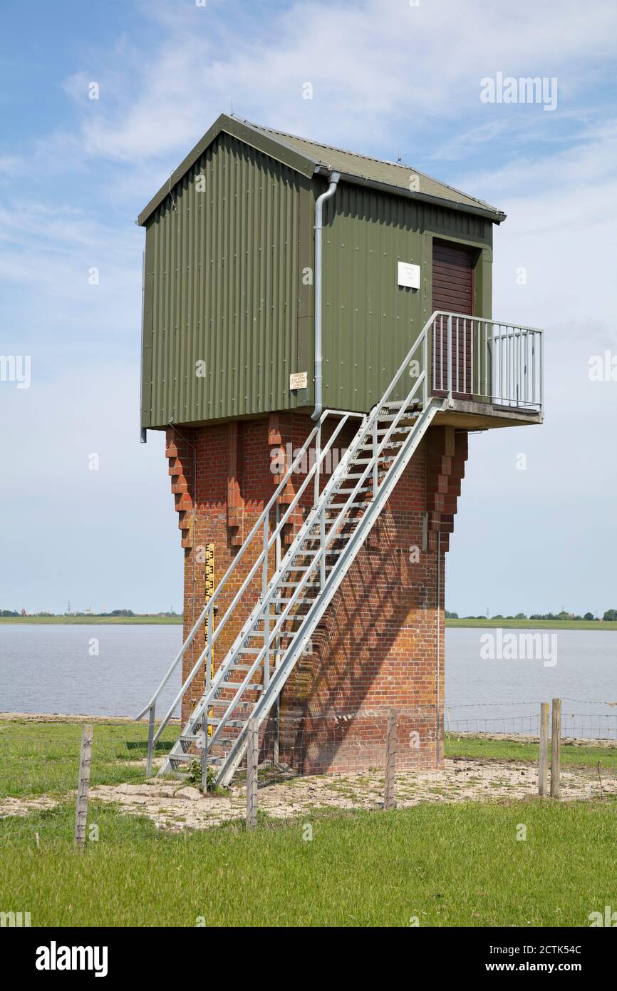 Germany, Lower Saxony, Ditzum, Water level obserwation tower on bank of Ems Stock Photo