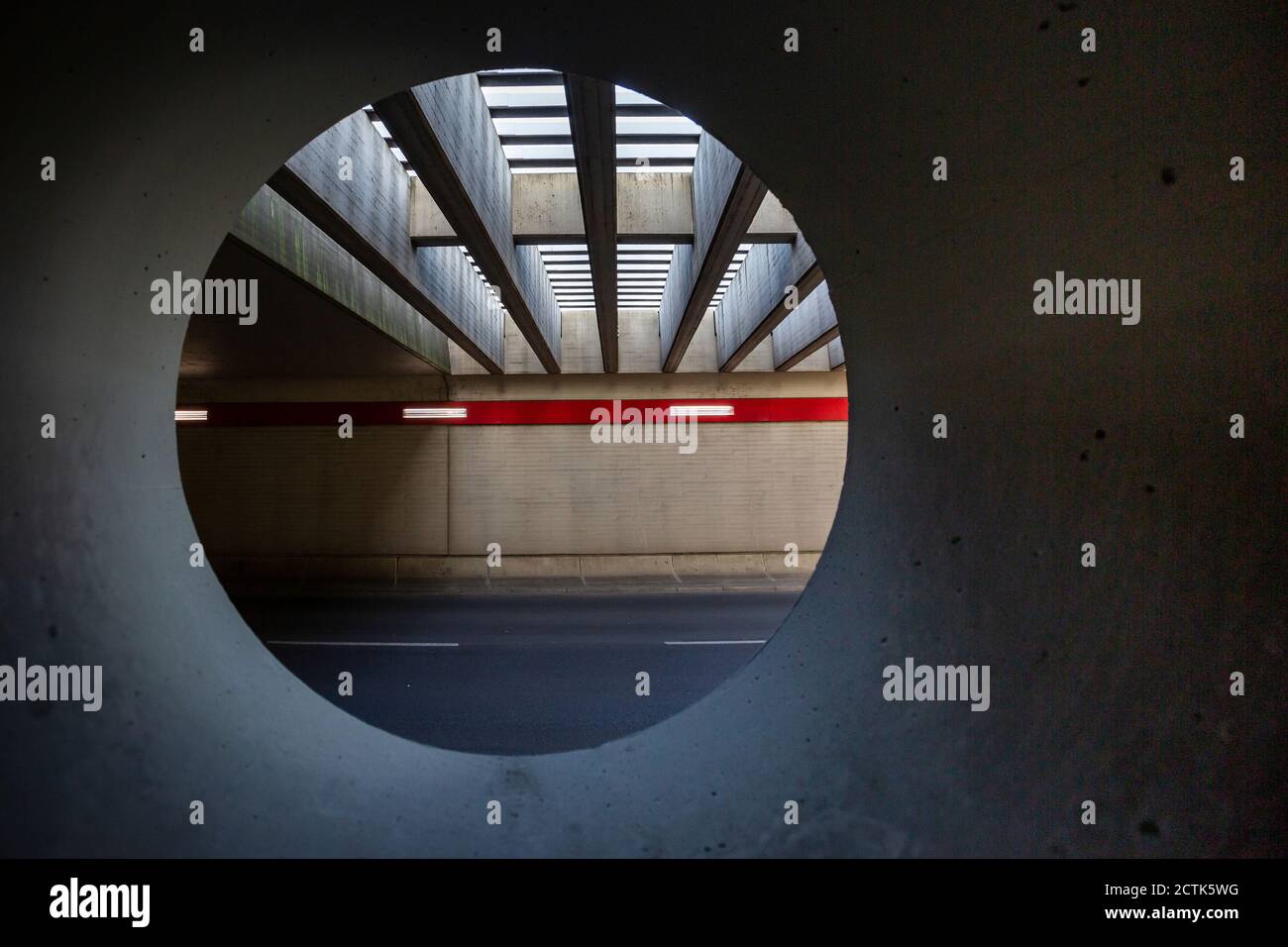 Germany, Berlin, Asphalt road at Berlin Tegel Airport seen from inside of circular tunnel Stock Photo