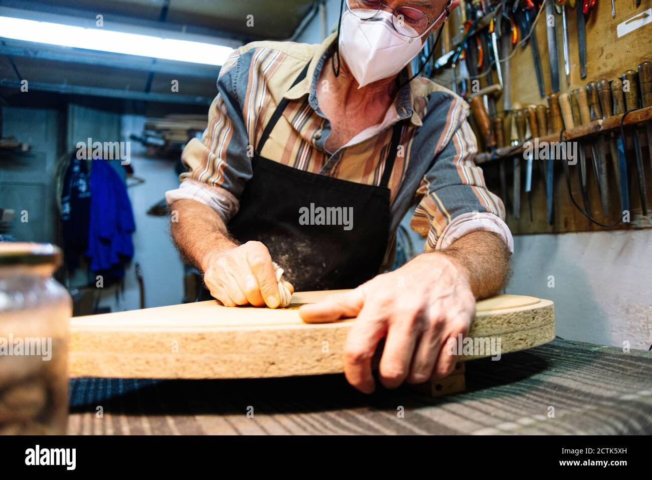 Instrument maker making lute at workshop Stock Photo