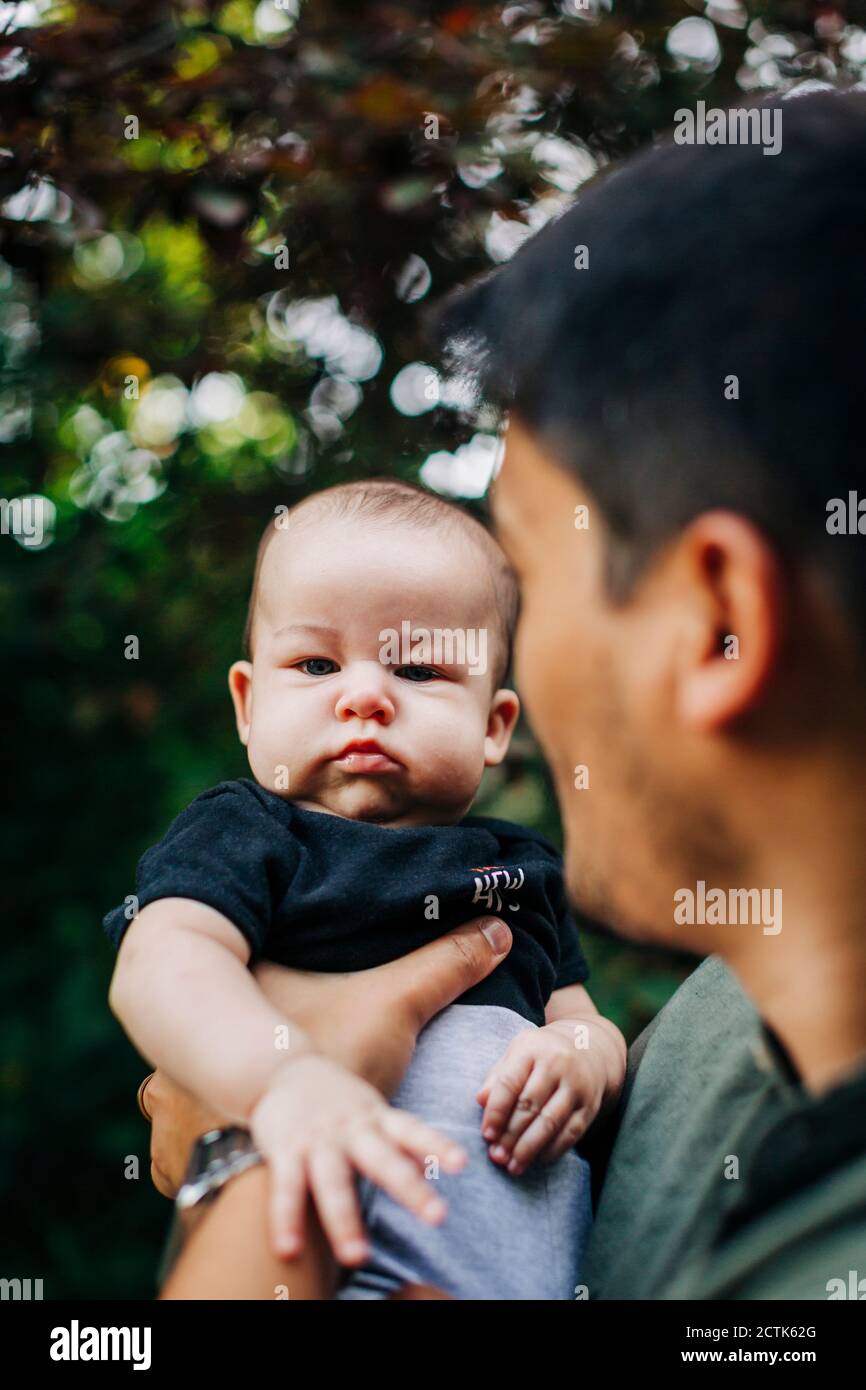 Cute baby boy with father at park Stock Photo Alamy
