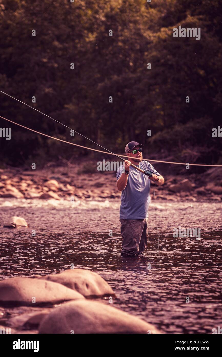 Fly fisherman casting with two handed rod in river Stock Photo