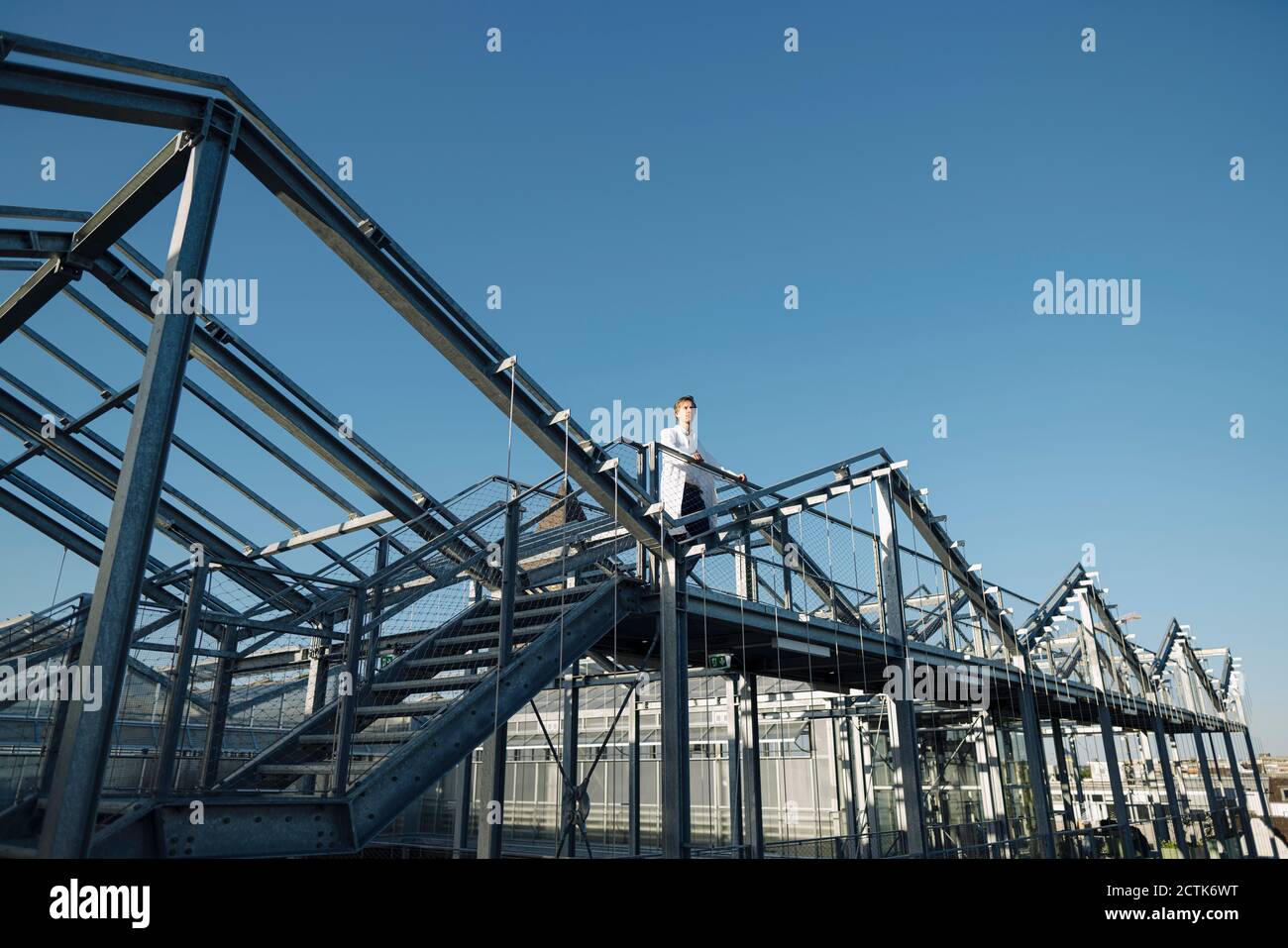 Scientist on a metal construction under blue sky Stock Photo
