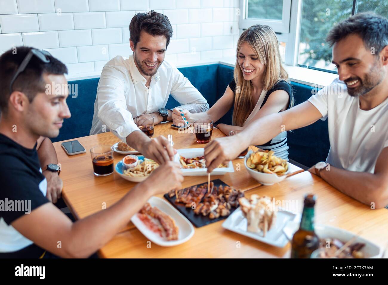 Friends having meal in restaurant Stock Photo