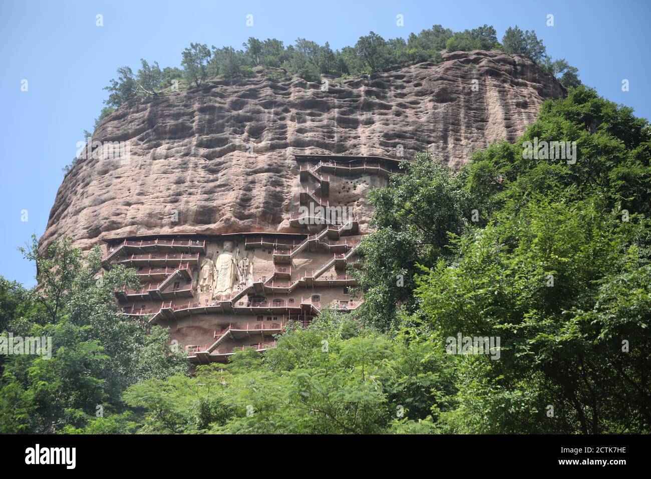 Sculptures of Buddhas are seen on the half of the mountain at the Maijishan Grottoes, a series of 194 caves cut in the side of the hill of Majishan, T Stock Photo