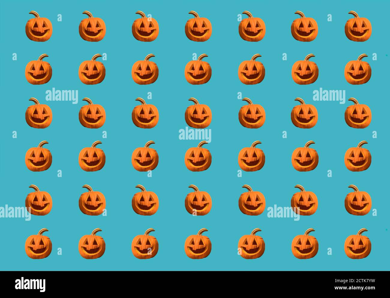 Halloween pumpkins pattern isolated on a blue background Stock Photo