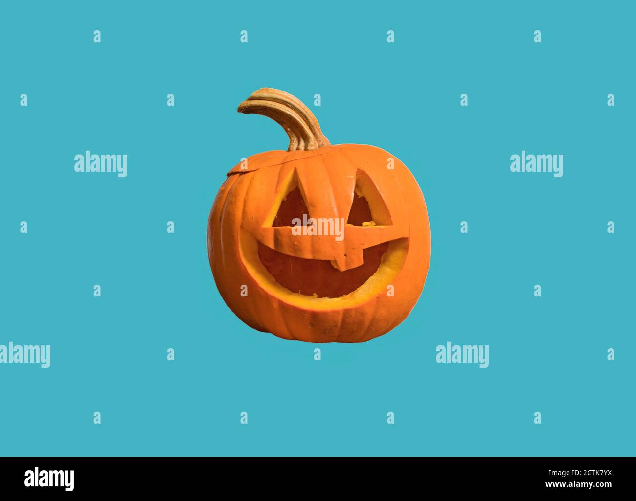 Halloween pumpkin with face, isolated on a blue background Stock Photo