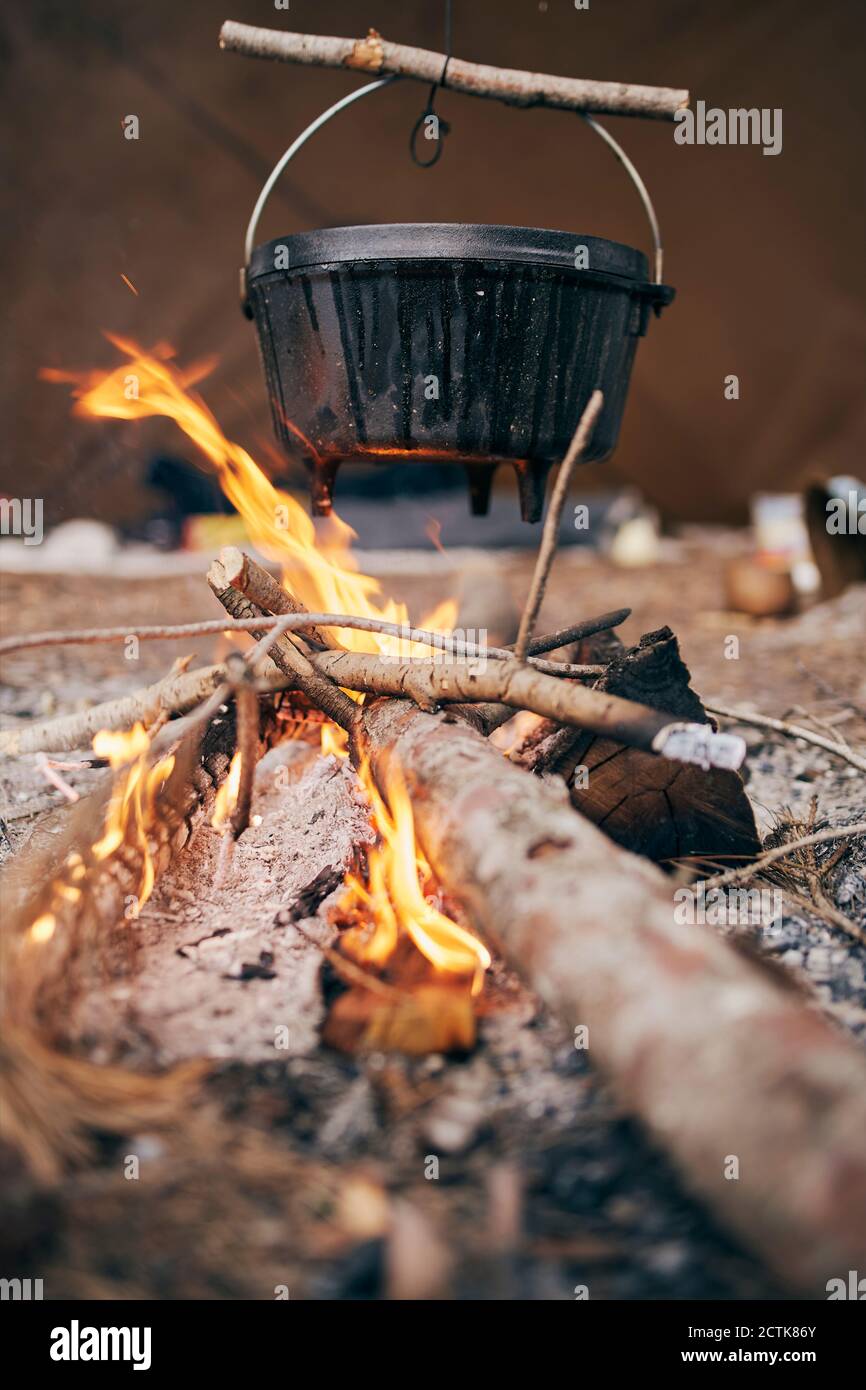 Pot hanged over campfire Stock Photo - Alamy