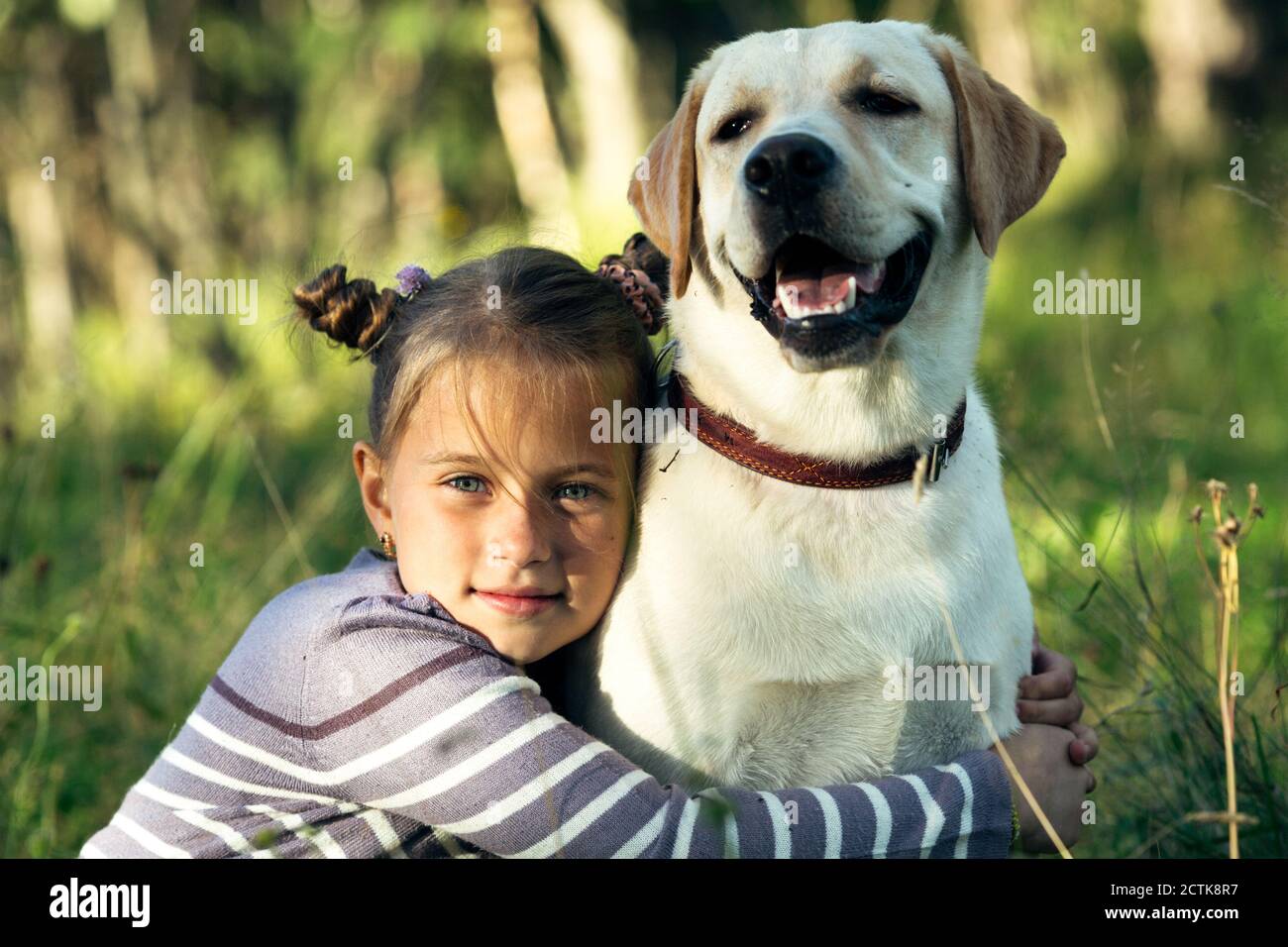 Little girl portrait with a dog in the park Stock Photo - Alamy
