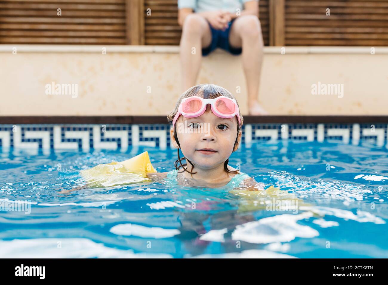Little girl with swimming goggles in swimming pool Stock Photo Alamy