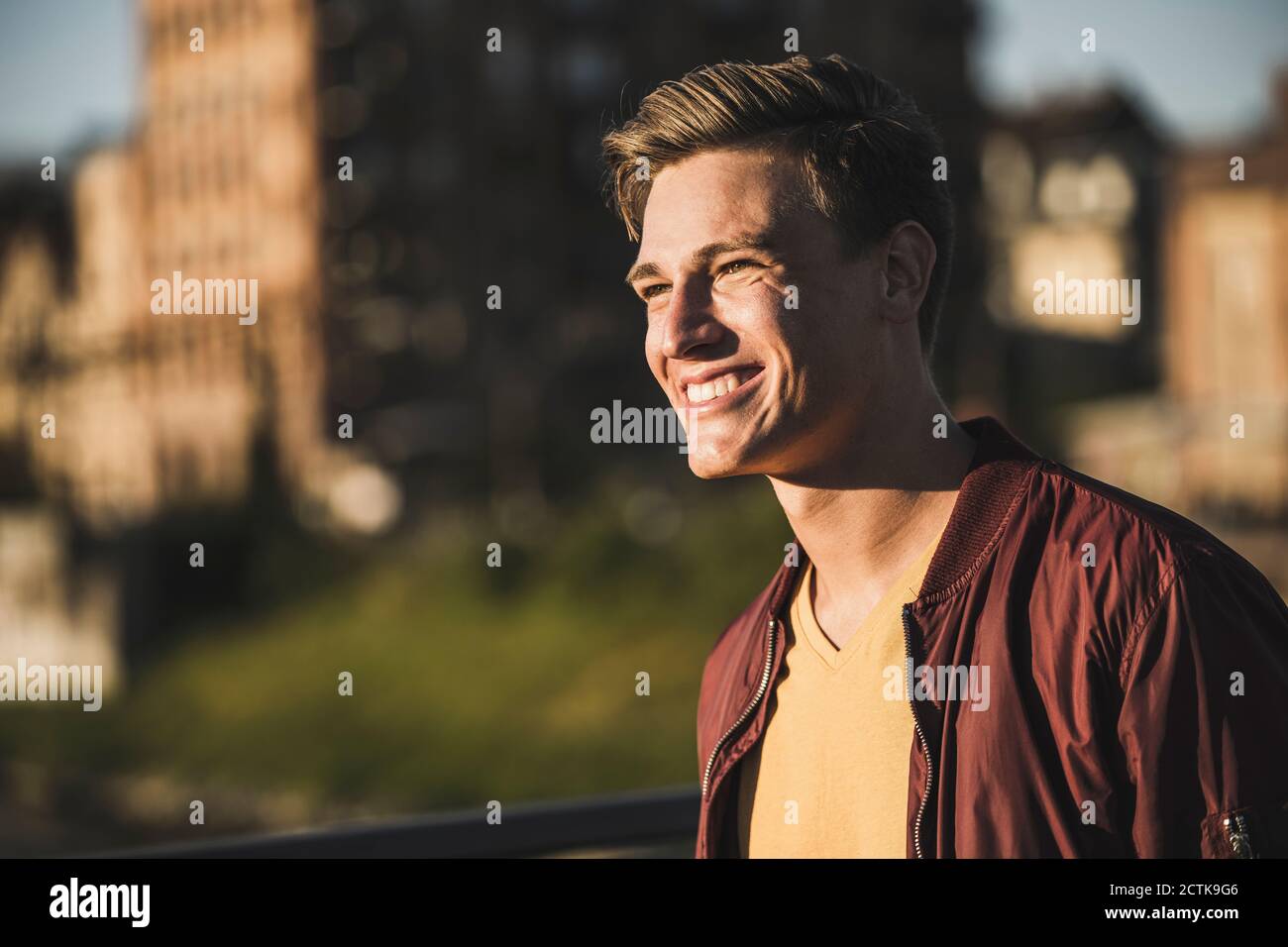 Smiling young man looking away Stock Photo