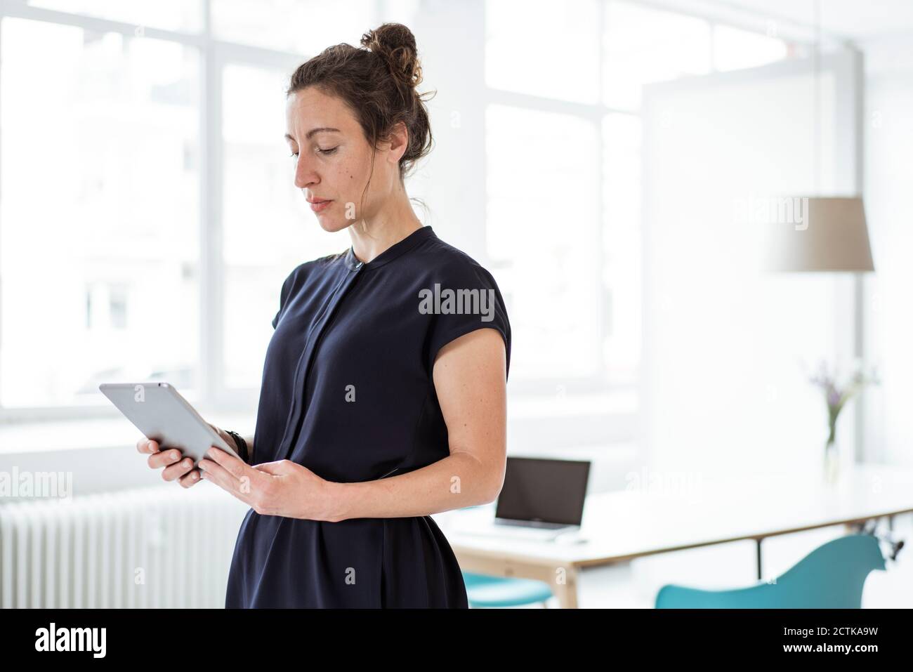 Female entrepreneur using digital tablet Stock Photo