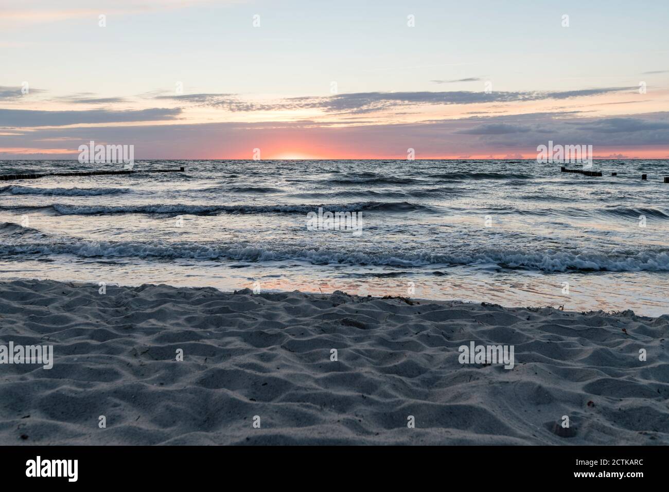 Sandy coastal beach of Baltic Sea at sunset Stock Photo