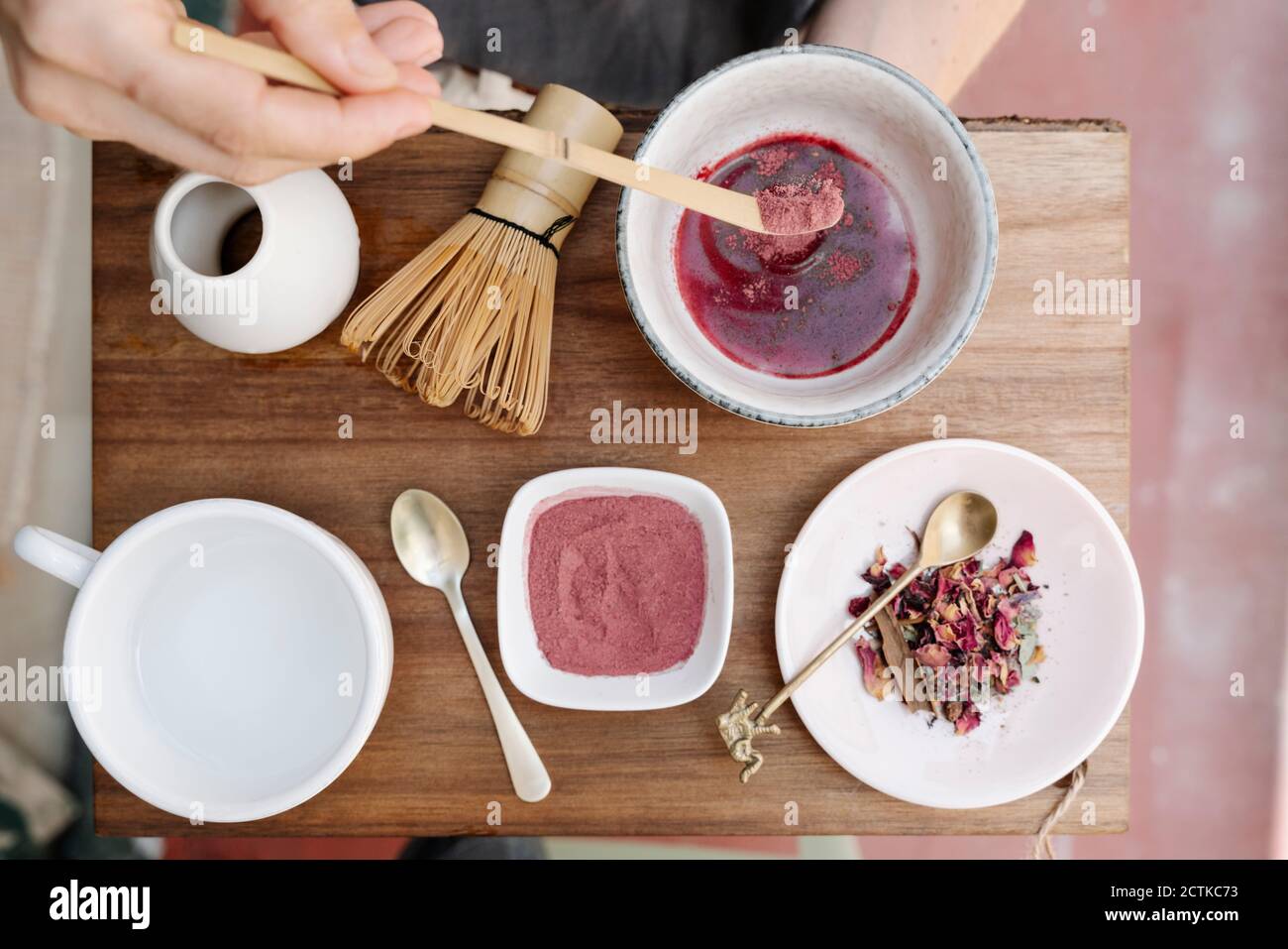 https://c8.alamy.com/comp/2CTKC73/hands-of-woman-holding-wooden-tray-while-making-matcha-tea-2CTKC73.jpg