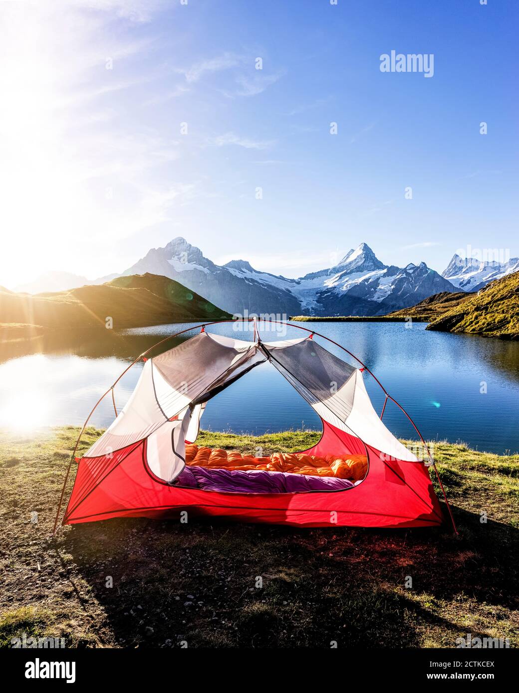 Tent pitched on shore of Bachalpsee at sunrise Stock Photo