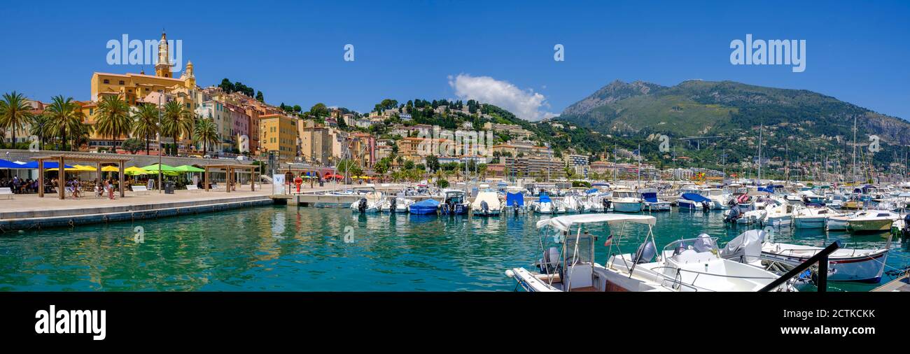 France, Provence-Alpes-Cote dAzur, Menton, Motorboats moored in harbor of coastal town in summer Stock Photo