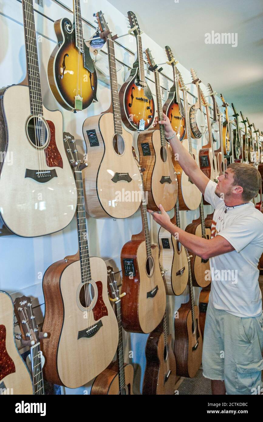Sevierville Tennessee,Music Outlet store business musical instruments sale shopping,inside interior,guitars display man male customer, Stock Photo
