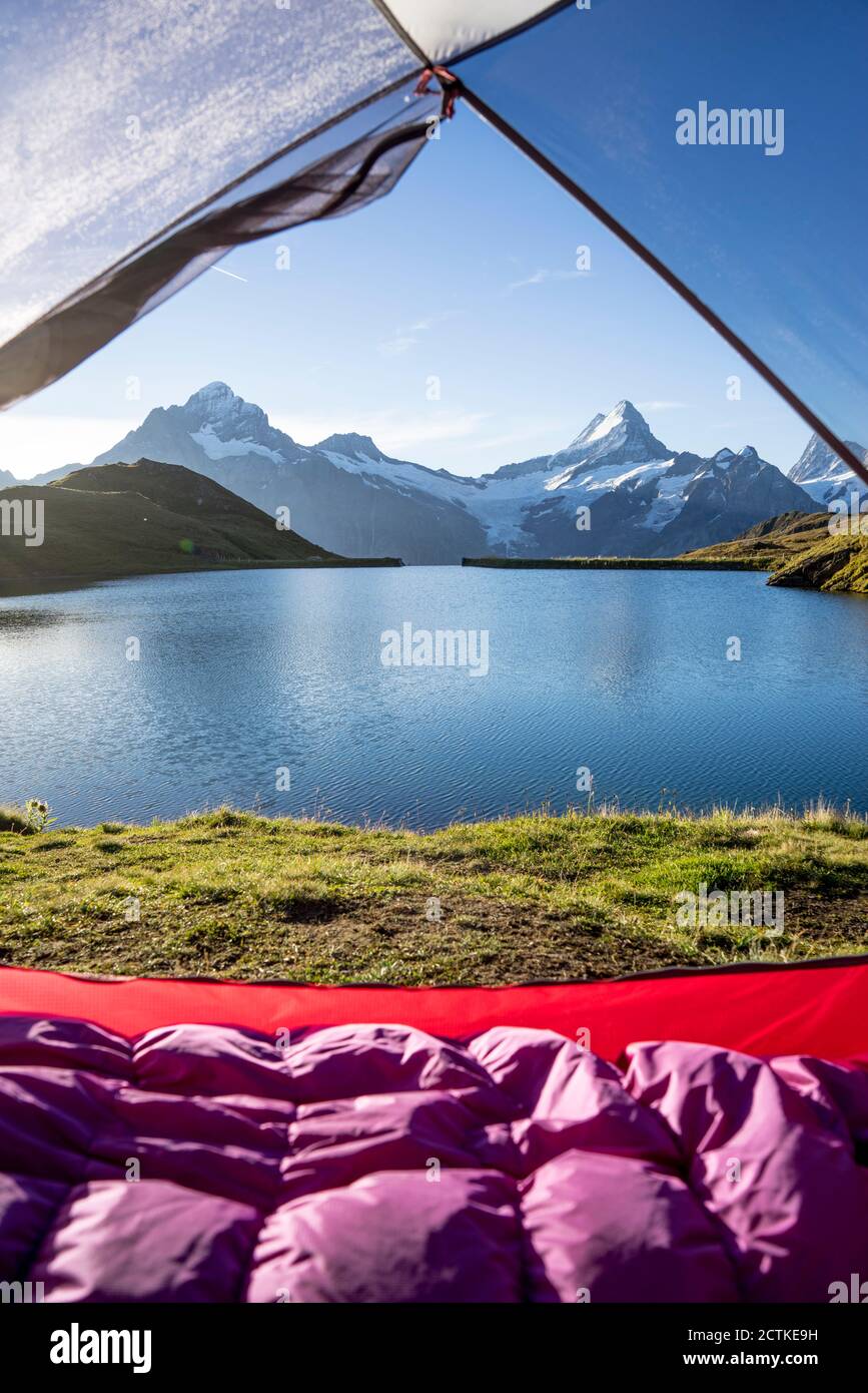 Tent pitched on shore of Bachalpsee at dawn Stock Photo