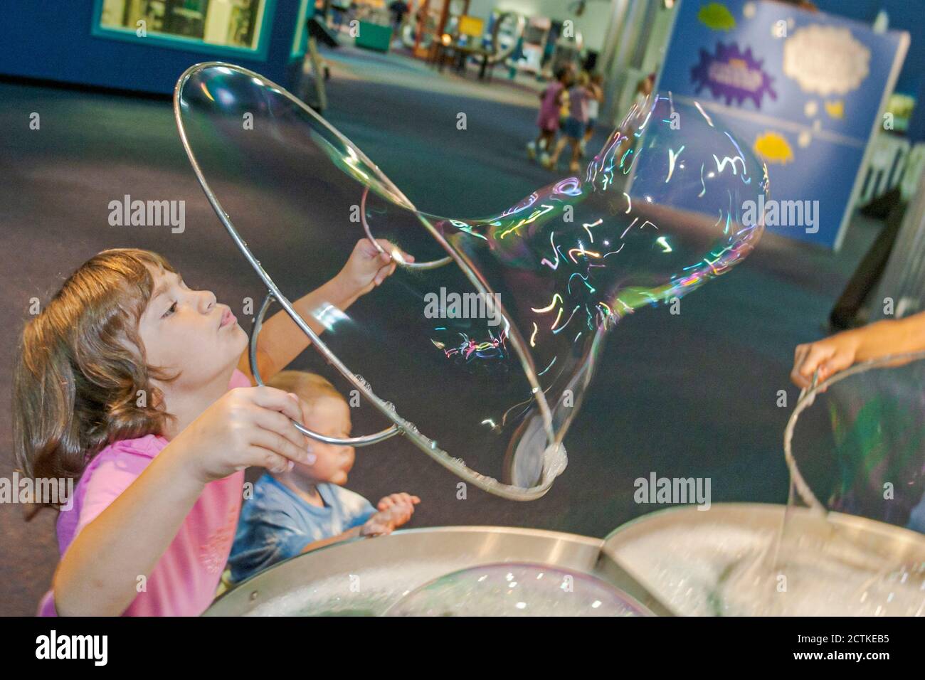 Huntsville Alabama,Sci-Quest Hands-on Science Center,inside interior girl making giant soap bubble bubbles Stock Photo