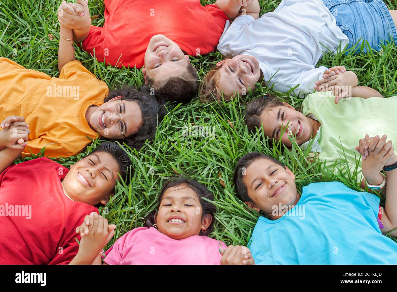 Miami Florida,Non Violence Project USA,teaching student students non violent behavior,boys boy girl girlss smiles smiling,hold holding hand hands circ Stock Photo