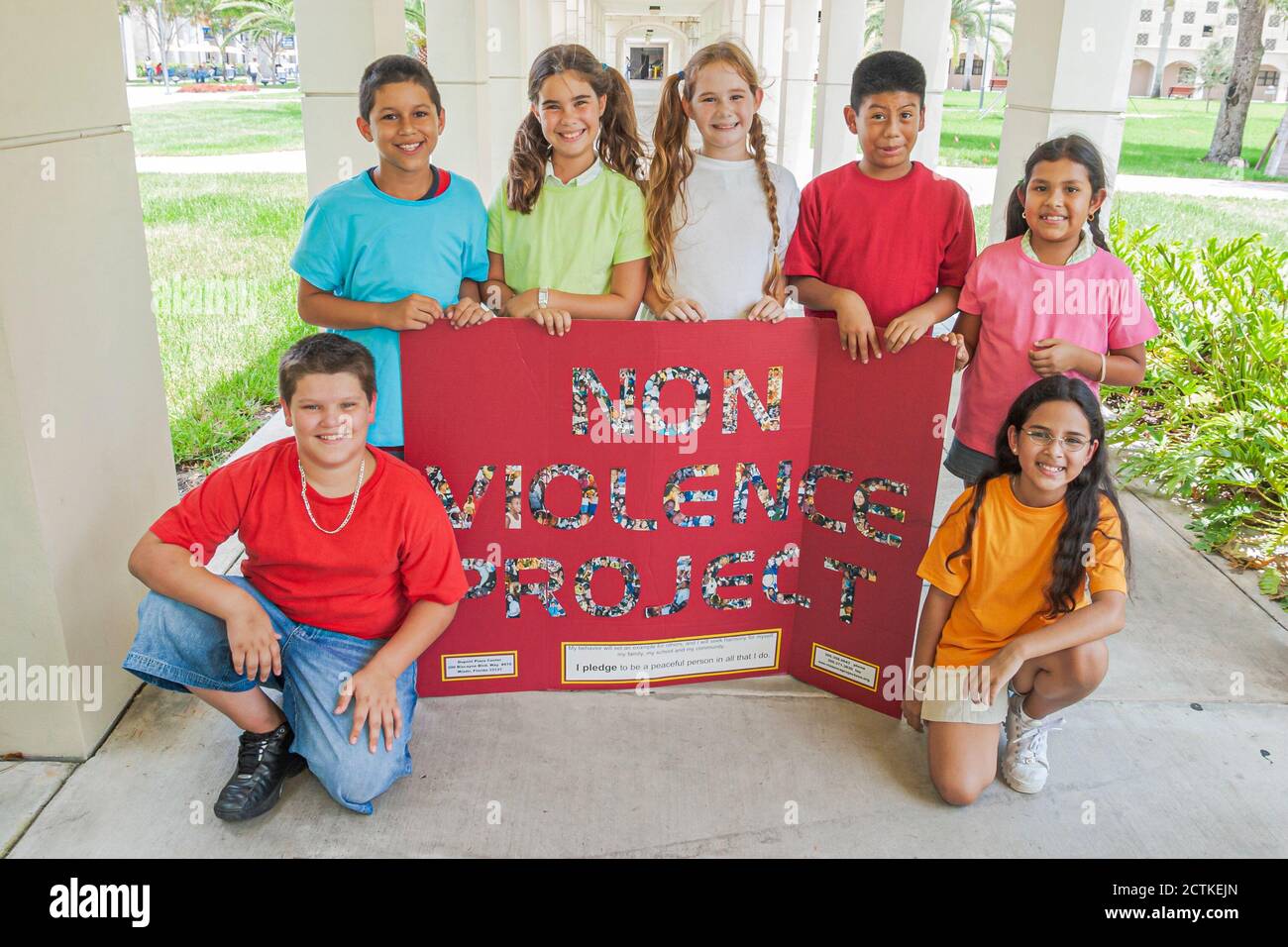 Miami Florida,Non Violence Project USA,teaching student students non violent behavior,boys boy girl girlss smiles smiling,hold holding poster sign,His Stock Photo