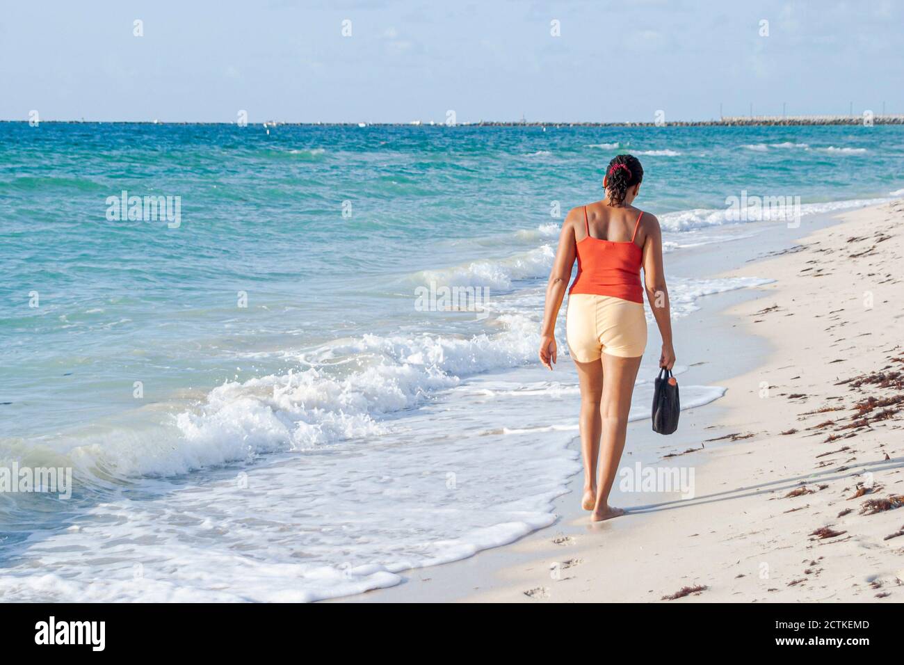 Miami Beach Florida,Black African Africans,adult woman female women,beachcomber walks walking Atlantic Ocean surf shore shoreline, Stock Photo