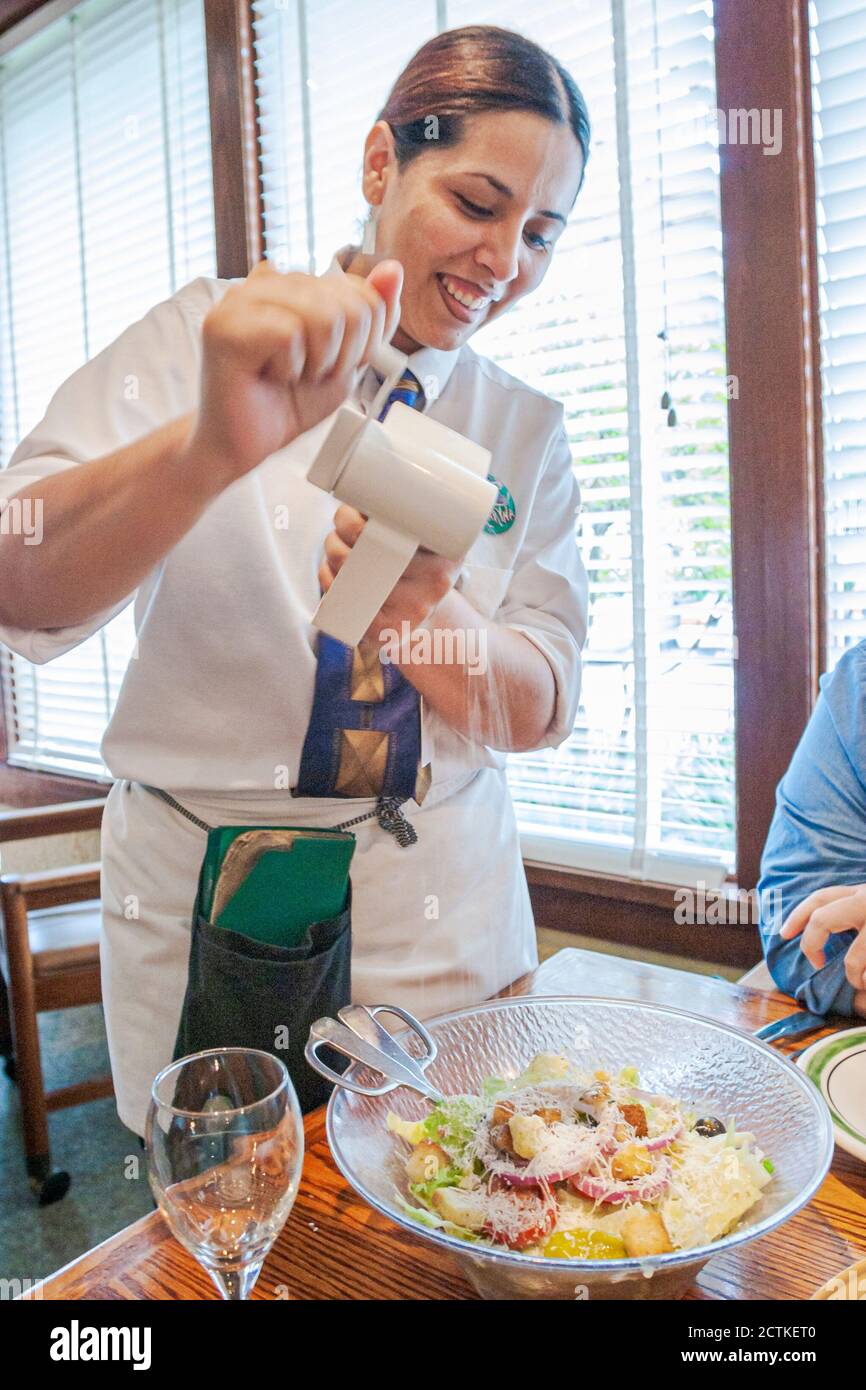 Miami Florida,Olive Garden restaurant restaurants,food dining,waitress server adds adding cheese grinder, Stock Photo