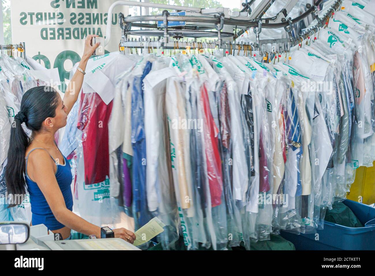Pulls order from moving rack of clean clothes hires stock photography and images Alamy