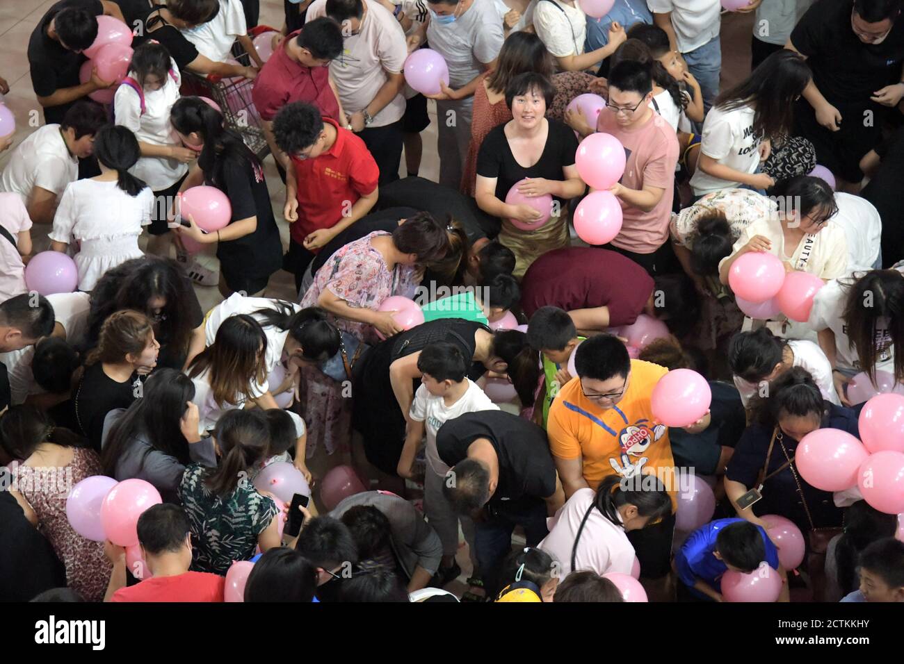 View of people fighting to get the balloons at a shopping mall in Binzhou city, east China's Shandong province, 23 August 2020.   Wudi County Labor Un Stock Photo