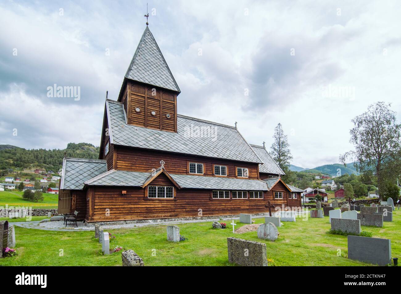 Horizontal photo of a Norwegian wooden stave church with its graveyard ...