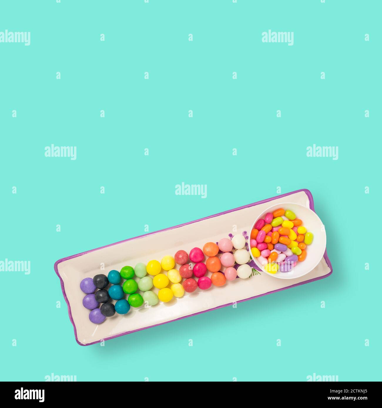 Colorful candies on a tray on a soft blue background. Photo with sweets ...
