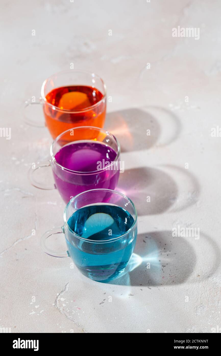 Glasses with colored liquid on a light marble background Stock Photo