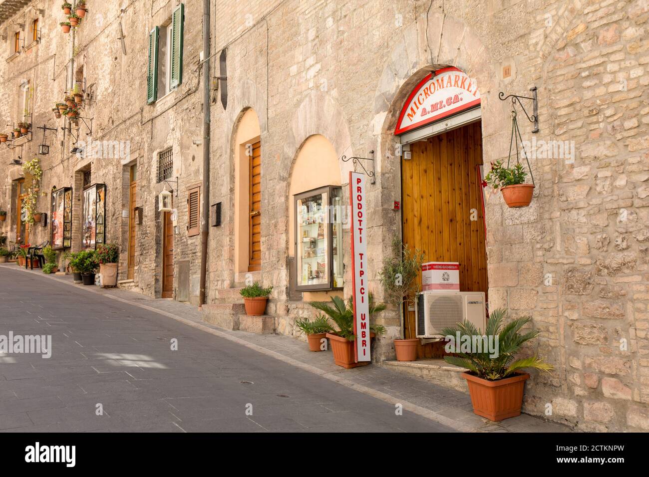 Assisi, Umbria region, Italy. Shops lining the street leading up to the