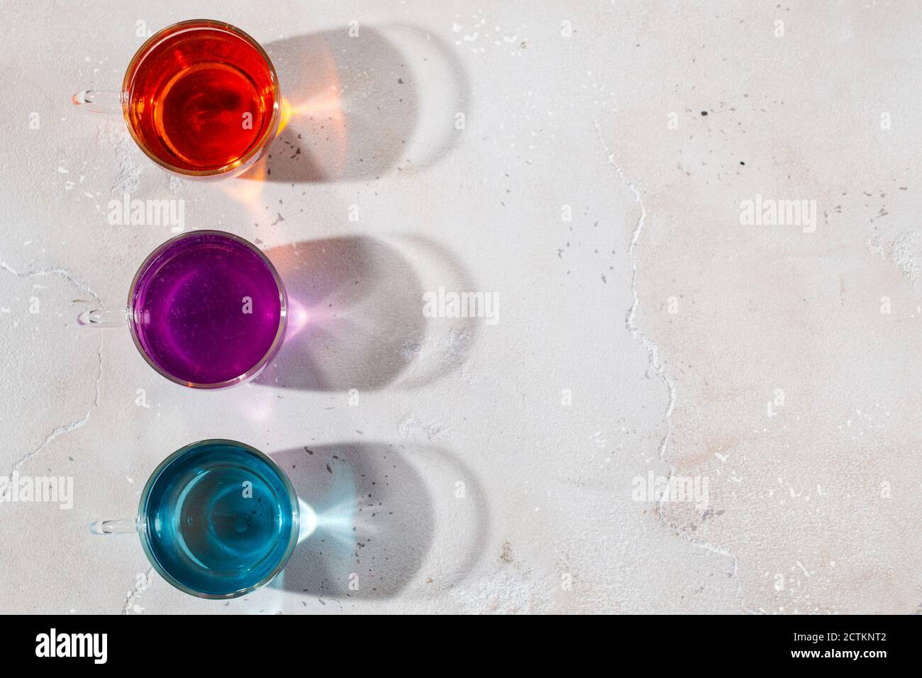 Glasses with colored liquid on a light marble background Stock Photo