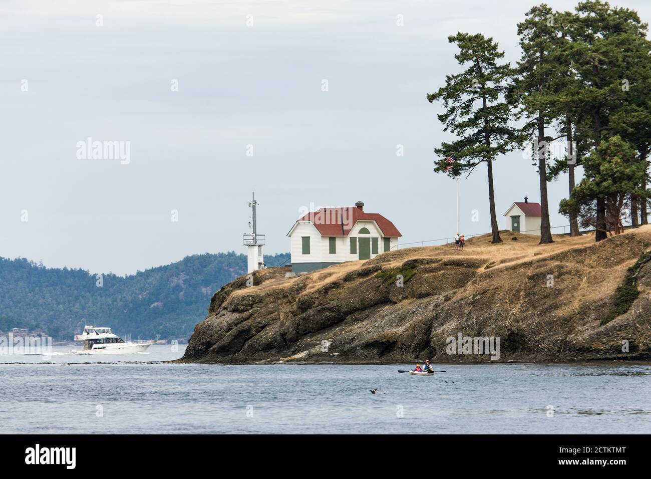 Lime Kiln Lighthouse tenderly watches over the whales and waterways at the entrance to Haro Strait, a major shipping route that links Puget Sound to t Stock Photo