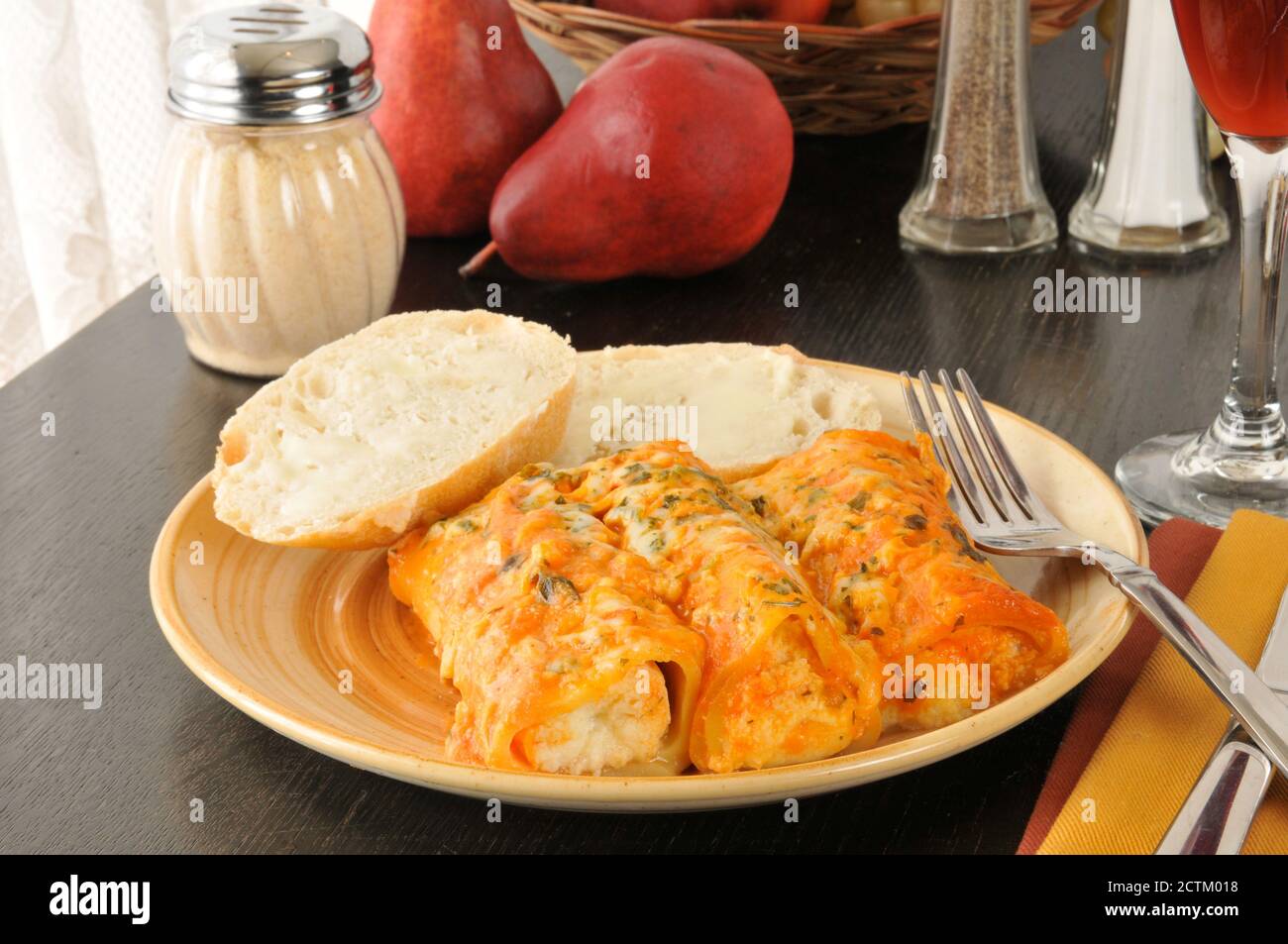 Four cheese manicotti with tomato vodka sauce and red wine Stock Photo