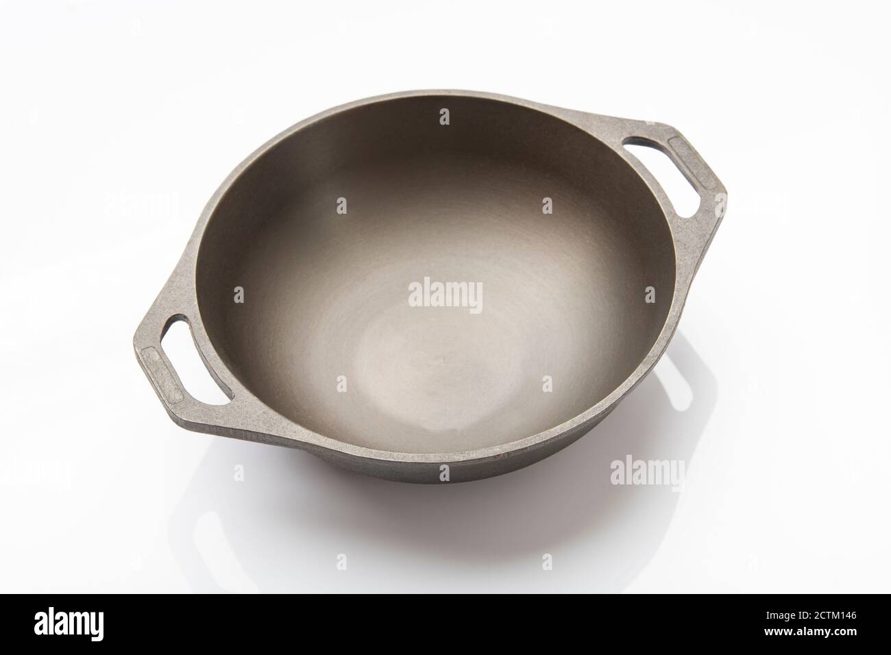 Top View of Seasoned Cast Iron Skillet on White Background Stock Photo