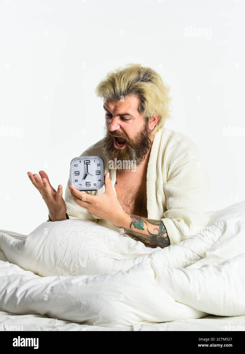 Awakening. Stressed man alarm clock. Sleepy guy and alarm clock in bed
