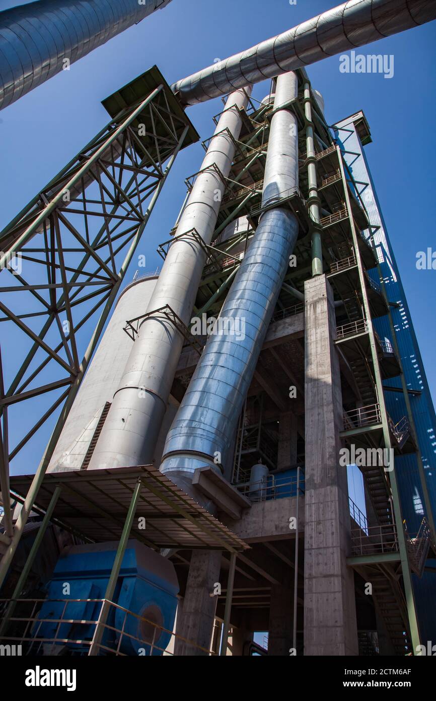 Mynaral/Kazakhstan - April 23 2012: Modern Jambyl Cement plant. The tower, silo and pipes on the blue sky. Stock Photo