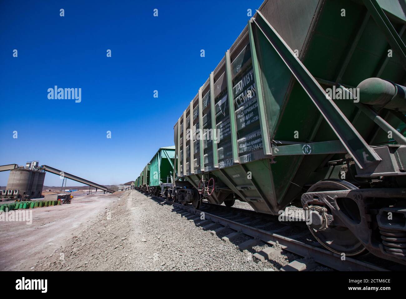 Mynaral/Kazakhstan - April 23 2012: Modern cement plant in desert. Cargo railroad terminal. Concrete silo and conveyor. Stock Photo