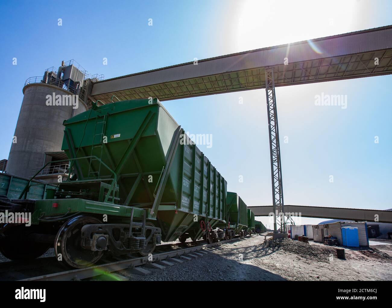 Mynaral/Kazakhstan - April 23 2012: Modern cement plant in desert. Cargo railroad terminal. Railway carriages with cement. Stock Photo