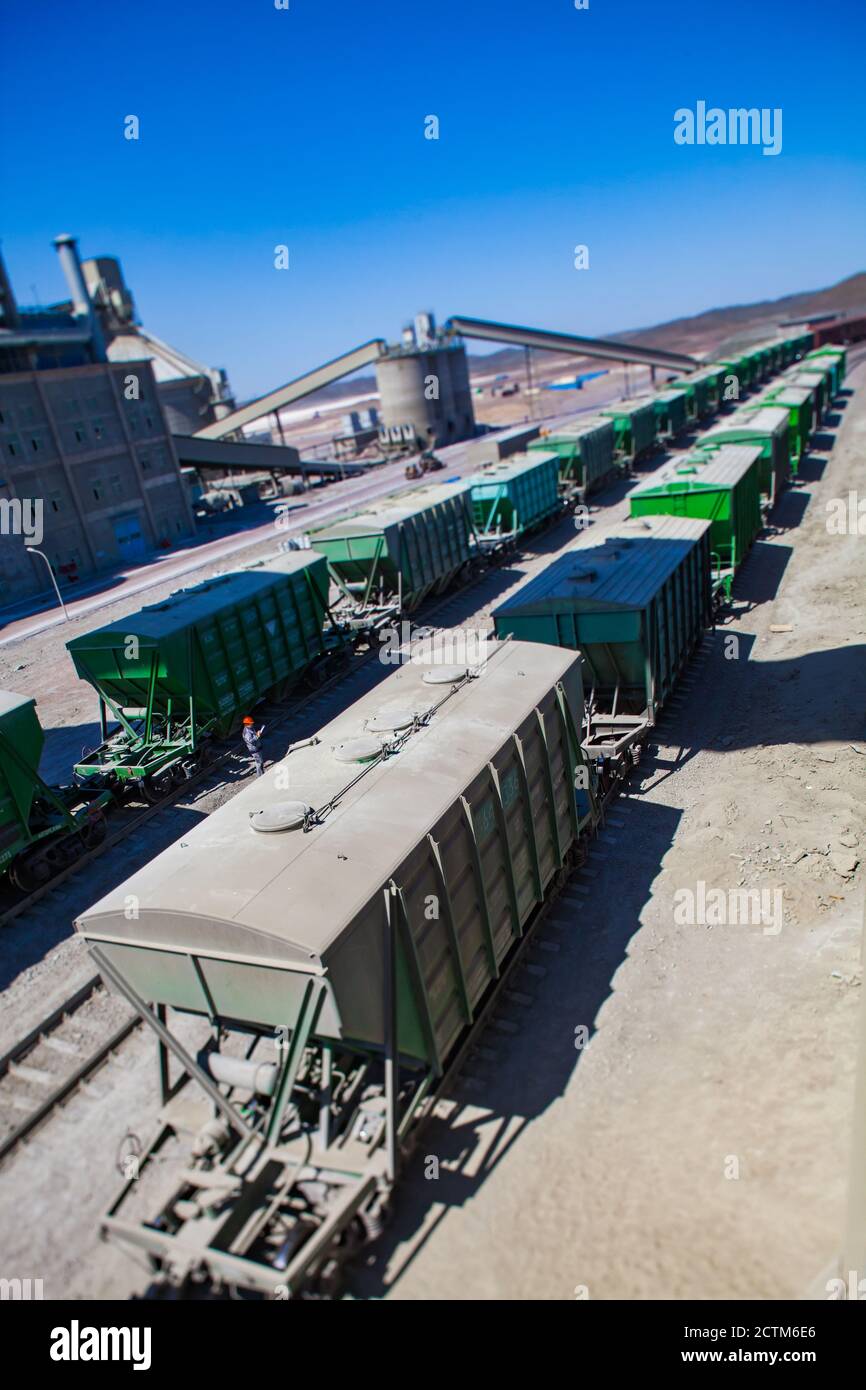 Mynaral/Kazakhstan - April 23 2012: Modern cement plant in desert. Railroad terminal for loading and filling. Tilt-shift partially blurred photo. Stock Photo