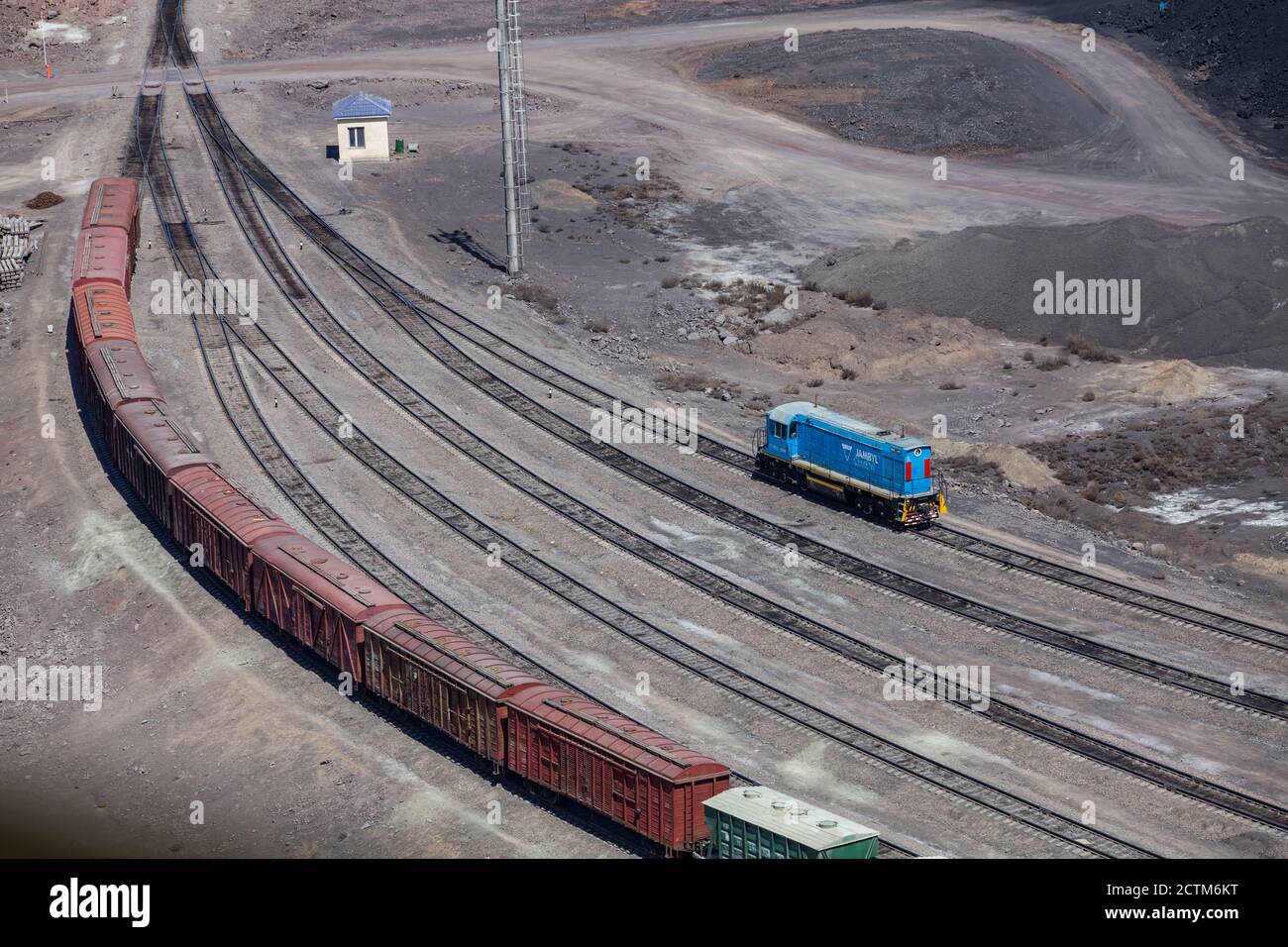 Mynaral/Kazakhstan - April 23 2012: Modern Jambyl-Cement plant in desert. Cargo train and locomotive on Railroad terminal. Aerial view. Stock Photo