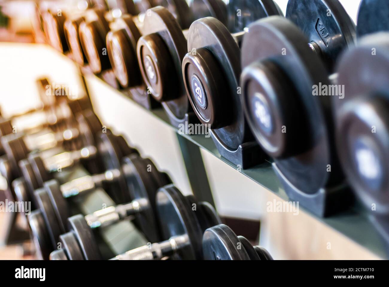 Rows of various dumbbells in the fitness. Healthy life and gym exercise equipments and sports concept. Stock Photo
