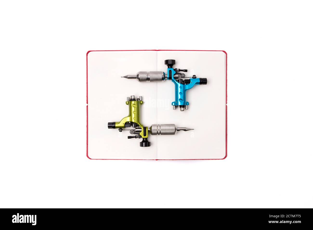 Tattoo machines with open notepad isolated on background. Tattooing