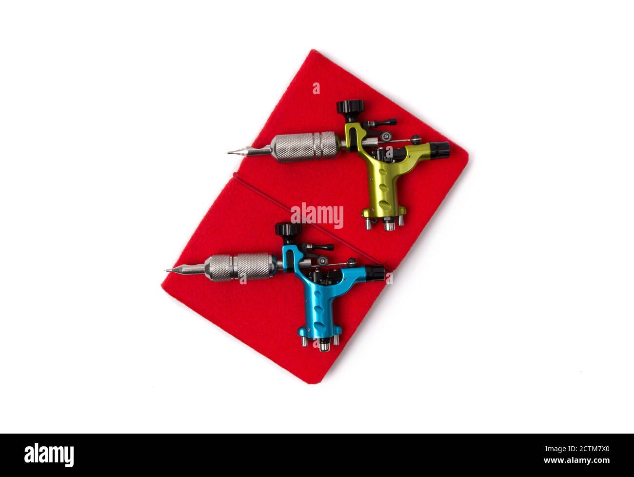 Tattoo machines with notepad isolated on background. Tattooing artist