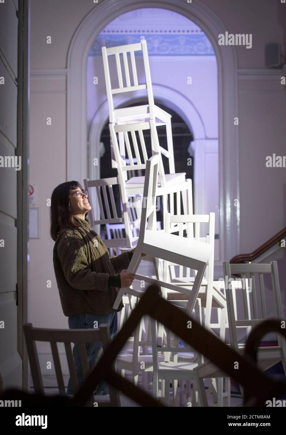 Set and costume designer Christine Urquhart, from Glasgow, helps to install a new installation titled #TakeASeat in the foyer of the Royal Lyceum Theatre in Edinburgh to celebrate Scotland's missing theatre and to let audiences know how much they are missed. Stock Photo